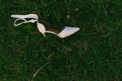 A film photo of a brides lost shoe at her wedding in the Bay of Plenty. Captured by Eilish Burt Photography