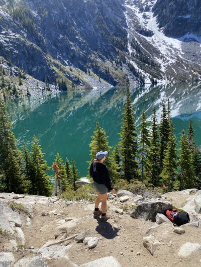 Image of a hiker looking out over a lake.