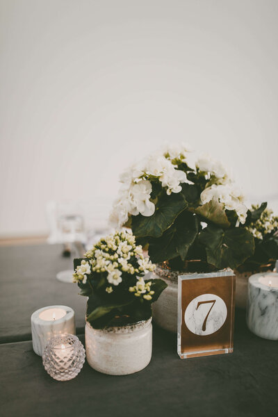 Wedding table centerpiece with flowers and candles.