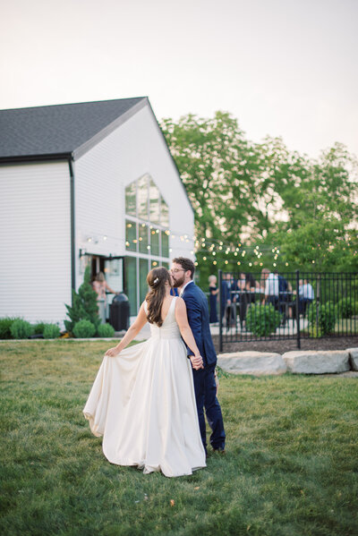 Photo of outdoor ceremony space with couple kissing