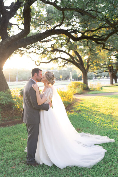 bride and groom kiss on their wedding day at the Museum of Natural Science by Houstons best wedding photographers Swish and Click Photography