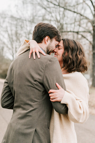 A daughter and son hug on their family lab during their family session.