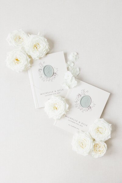 White vow books with blue wax seals