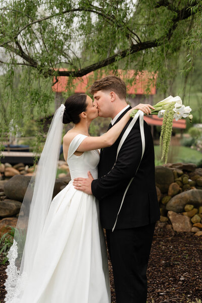 A bride and groom dip for a kiss at the end of their ceremony.