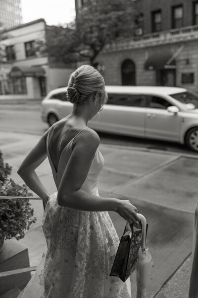 A photo of an elegant bride waiting for limo in downtown Chicago before wedding reception taken by Allexx B Photograhy