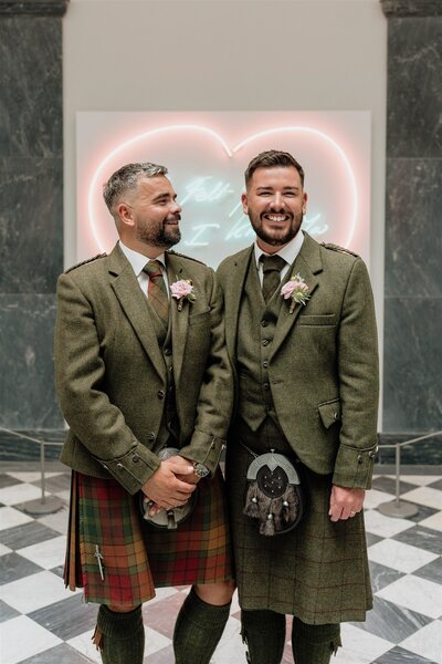 A couple pose candidly for wedding photos in Aberdeen Art Gallery.