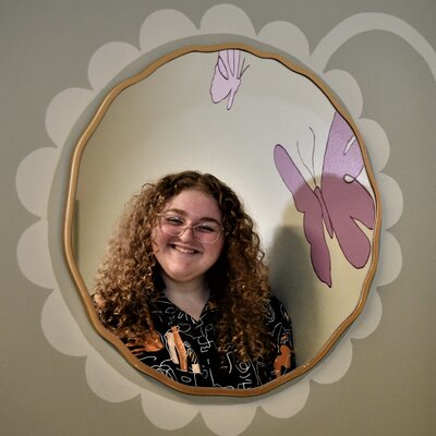 esthetician in round mirror