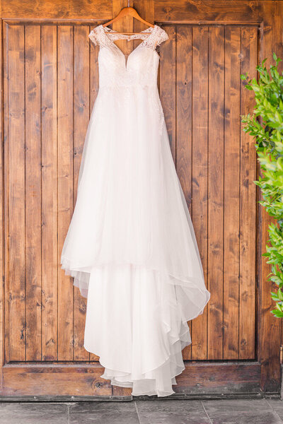 wedding dress hanging on wooden doors