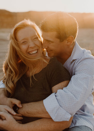 claremore newborn photographer smiling reallly big with her husband
