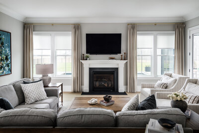 Cozy living room in Lake Norman, NC, featuring a neutral palette, fireplace, and modern home interior design.