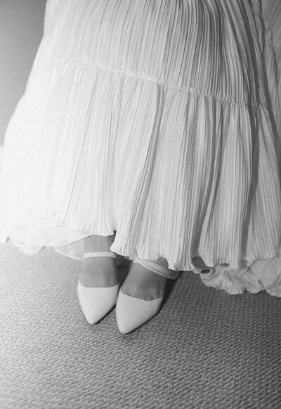 Bride's pleated wedding dress and pointed toe wedding heels