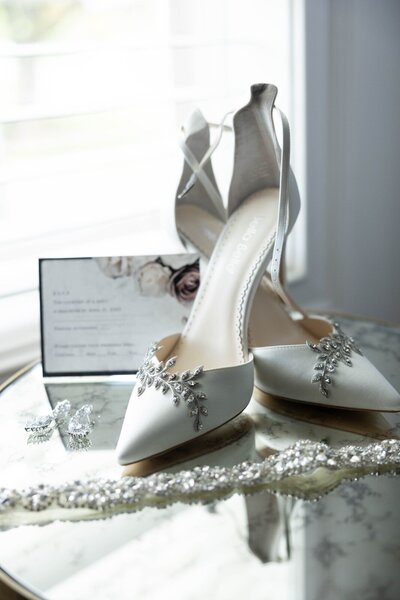 Bella Belle wedding shoes and bridal jewelry on mirrored table at Ritz Charles Carmel Indiana.