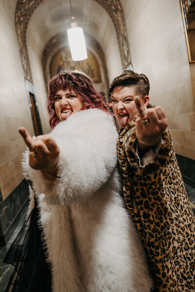 cool-middle-finger-vibes-engaged-lgbtq-brides-couple-faux-fur-jackets-kelly-kaz-upstate-new-york-photographer-buffalo-beyond