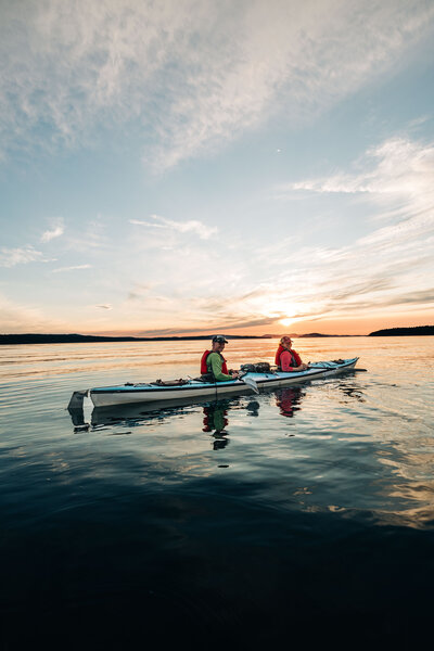 Couple's photo kayaking on lake in the Pacific Northwest