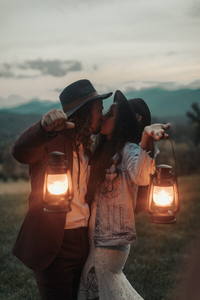 couple kissing and holding lanterns