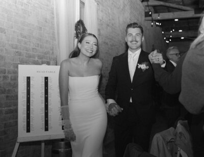 bride and groom holding hands walking into wedding reception