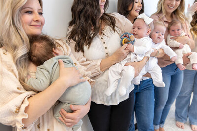 Group of mothers holding their babies