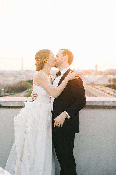 sunset-bride-groom-kissing-dc-rooftop-101-constitution