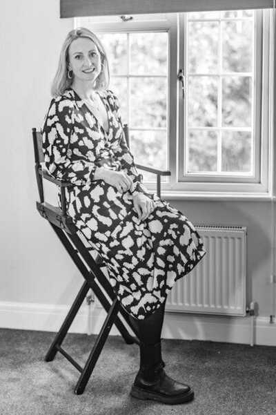 Kate Waller sitting on a chair, black and white