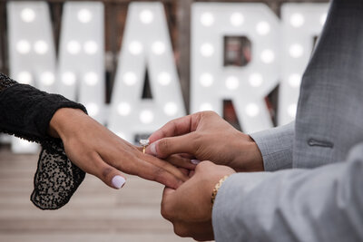 close-up picture of an engagement ring being placed on an Indian girl's hand.
