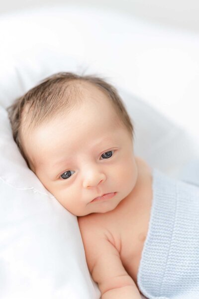 newborn baby girl sleeping on a white pillow with Constance Calton photography in Savannah, Ga