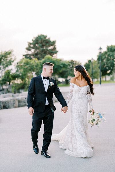 Bride and groom walking hand in hand during wedding at Pearle Hotel near Toronto