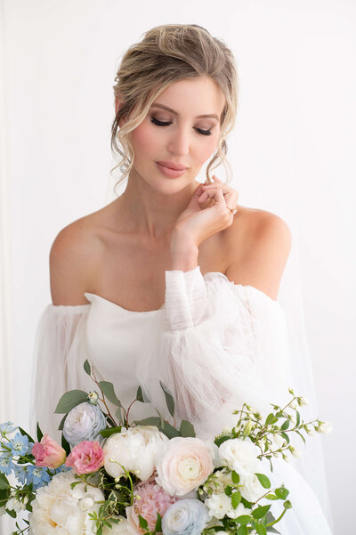 3/4 length classic portrait of a bride holding her bouquet taken by Ottawa Wedding Photographer JEMMAN Photography