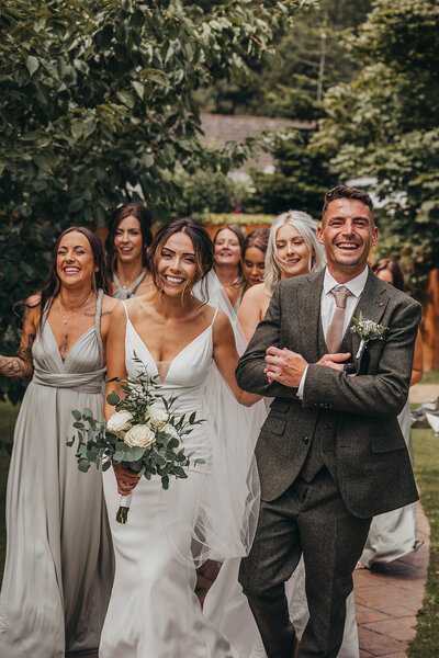 wedding party walk towards camera