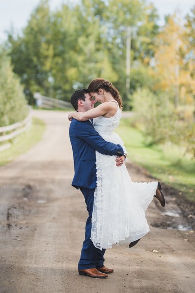 Groom Holding Bride at Alberta Wedding