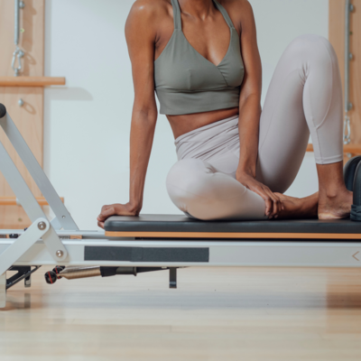 Pilates reformer session with a woman – Muse offers creative branding, social media management, and web design services for fitness professionals and wellness brands in Sydney