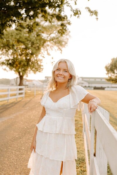 guest leaning against fence, captured by nashville wedding photographer