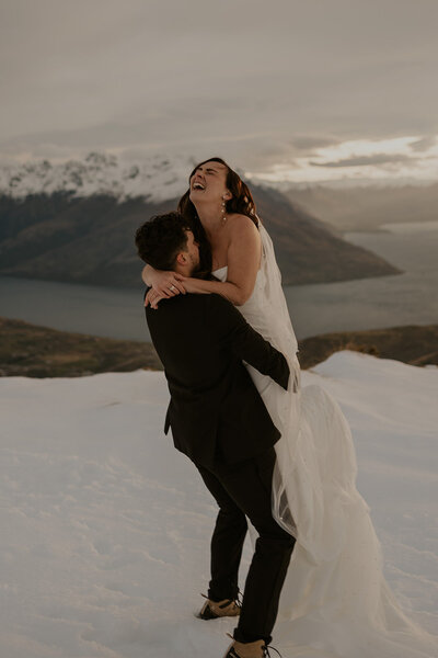amy and nick embrace on mountain