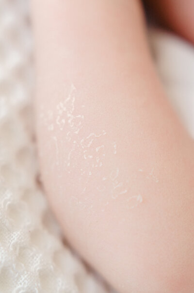 A detail image of a newborn baby's arm, taken by Amsterdam-based photographer, Sim Sawyers. 