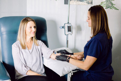 nurse helping child with Infusion Therapy