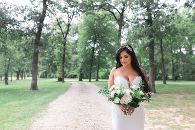 bride holds her wedding bouquet at Balmorhea Wedding Venue in Houston by Swish and Click Photography