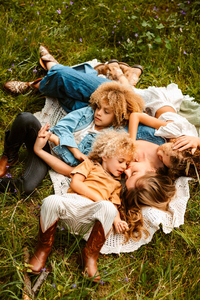 family all cuddled together in field in flagstaff arizona