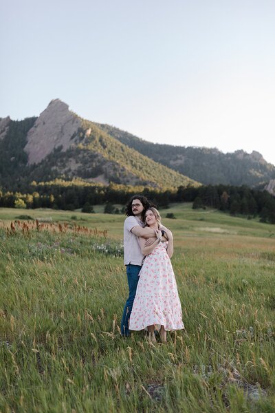 couple sitting outside gondola atop a denver rooftop engagement venue