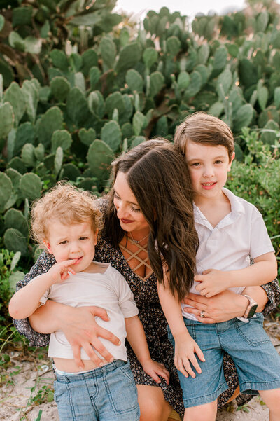 Stunning boy mom hugs her boys during their family session