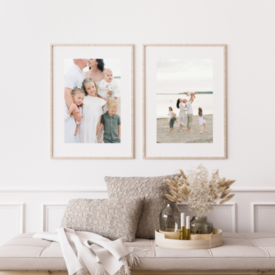 Two framed family portraits on a wall
