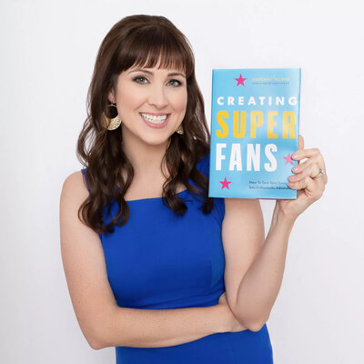 Brittany Hodak, posing with the hardcover of "Creating Superfans."