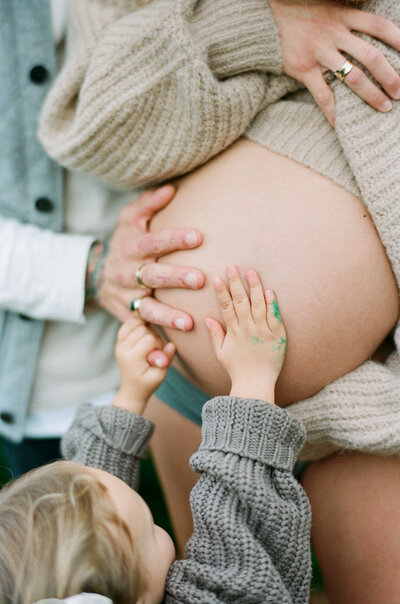 A sweet moment from a natural family photoshoot in Sydney celebrating a growing family