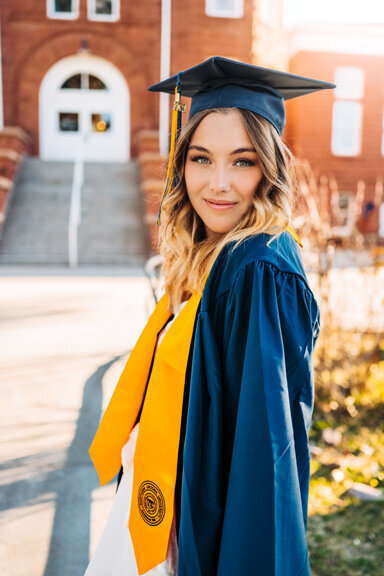 Senior grad dancing in a field on snowbowl in flagstaff, arizona.