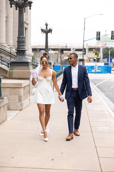 an engaged couple walking in a downtown area