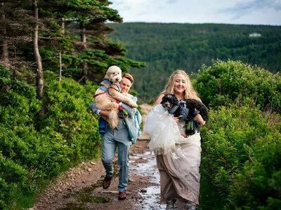 Wedding couple walking through mud on Nova Scotia adventure elopement with Fox and Fellow.