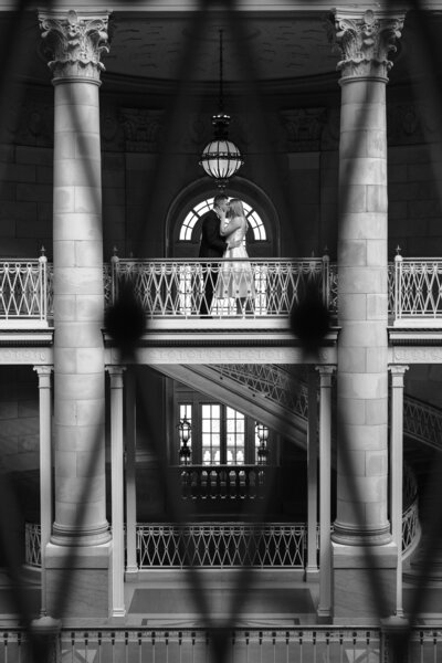 Engaged couple kissing at Hartford City Hall
