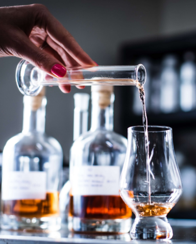 whiskey pouring into glass at whiskey tasting event