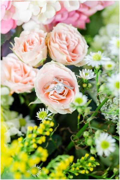 groom twirls bride in open floral area
