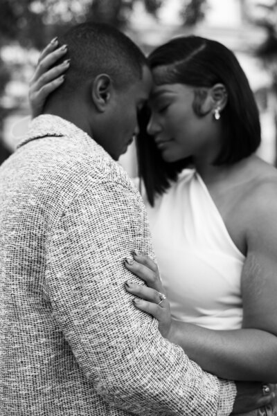 A couple with closed eyes embracing at Arthur Blank Foundation in Atlanta, GA