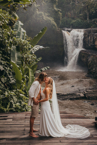 bride and groom at waterfall