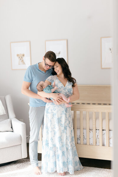 Swaddled baby girl with feet out and bow on head